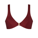 Woman wearing the ERY brown bikini top with gold clasp, minimal and sport-chic cut – handcrafted in Italy